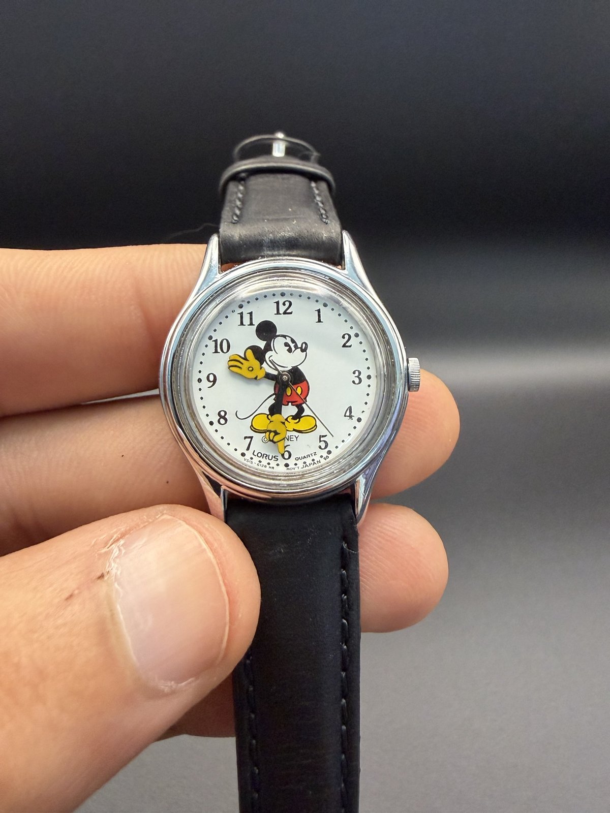 Lorus Mickey Mouse watch held in hand