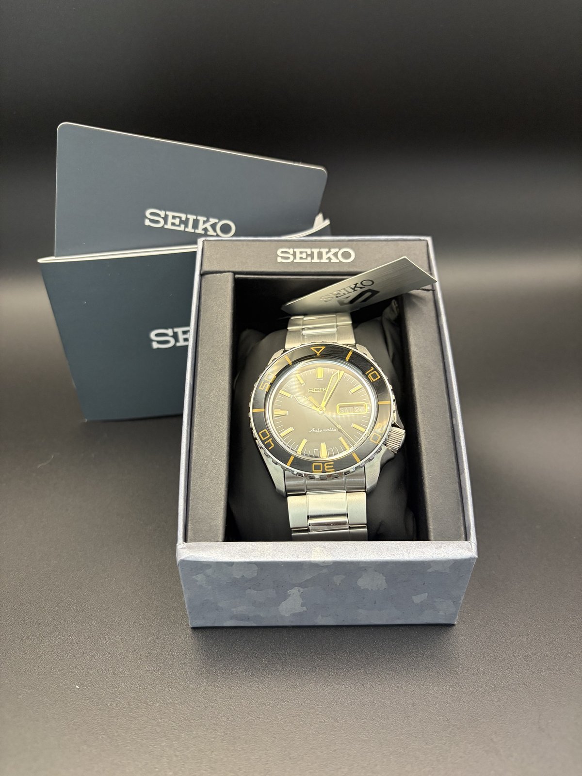Seiko 5 Sports in its box with the manual