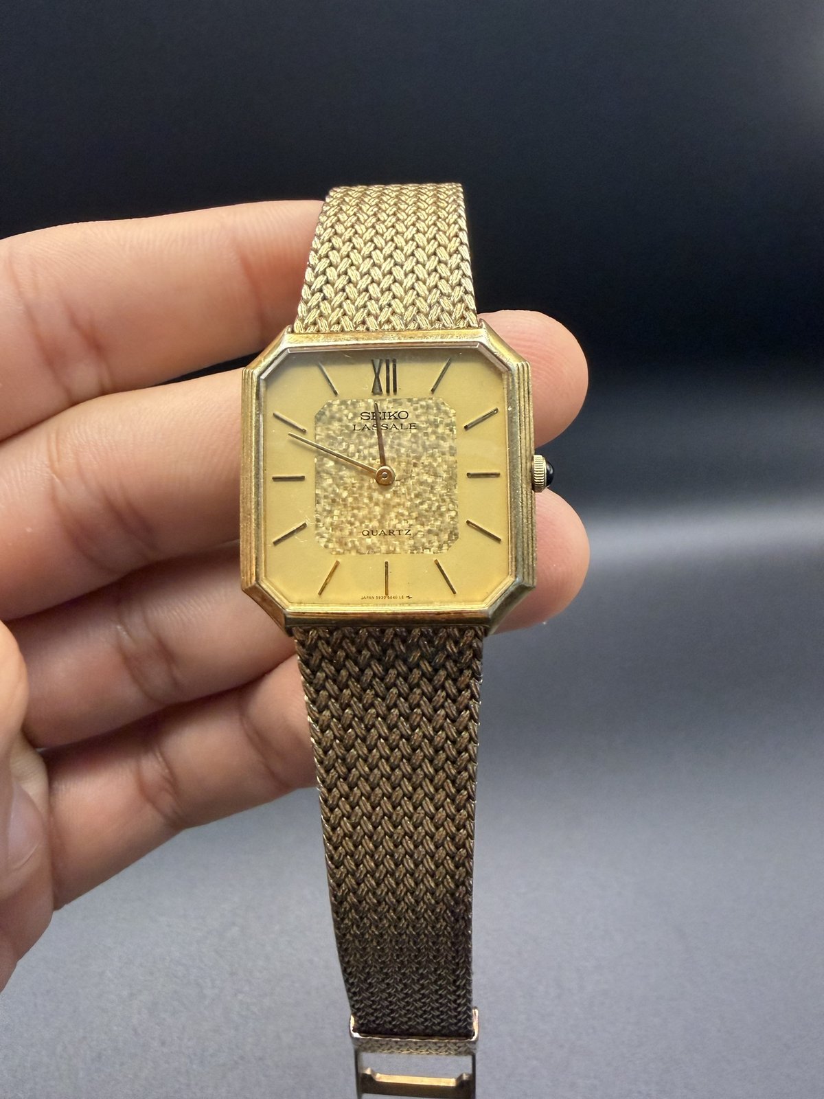 Seiko Lassale dial with gold textured centre panel, held in hand